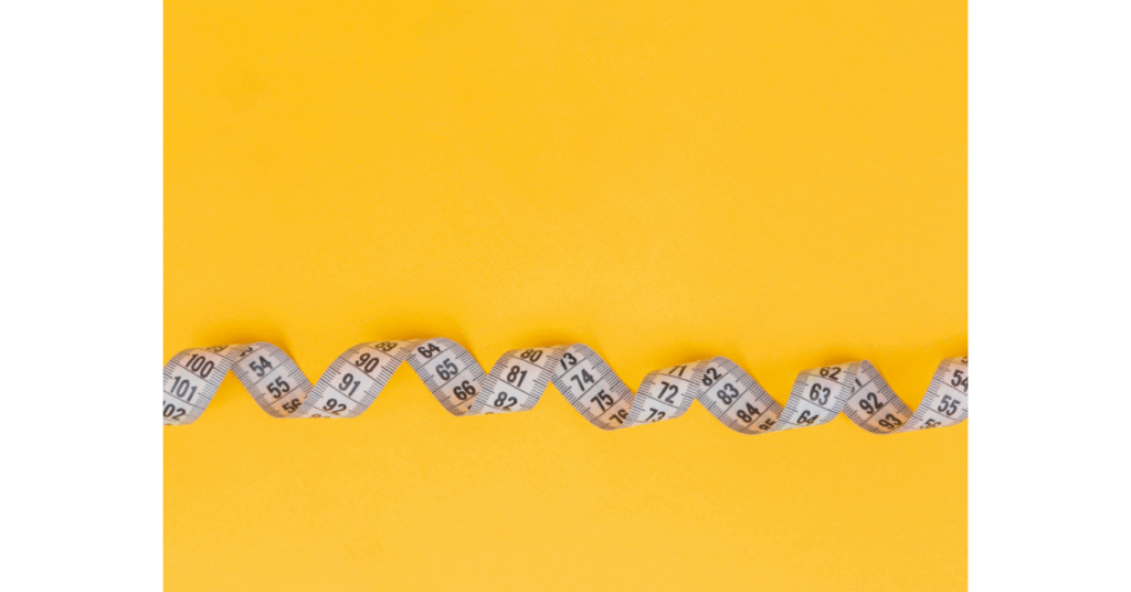 Measuring tape showing how to measure a dog for a crate