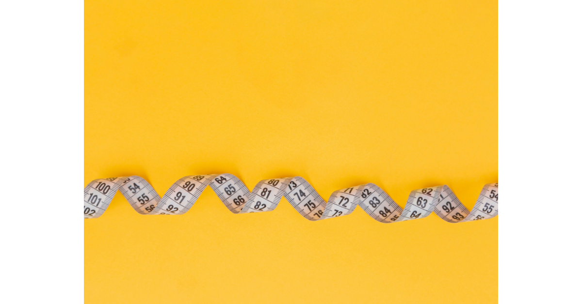 Measuring tape showing how to measure a dog for a crate